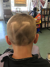 Back view of a kid's fresh haircut with a custom design